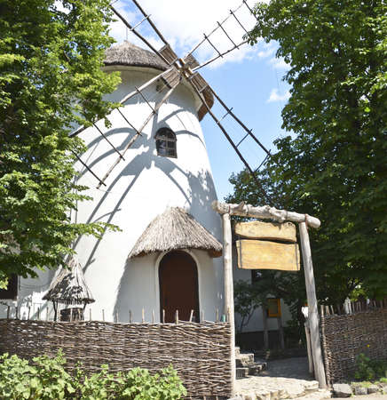 windmill beyond wicker fenceの写真素材