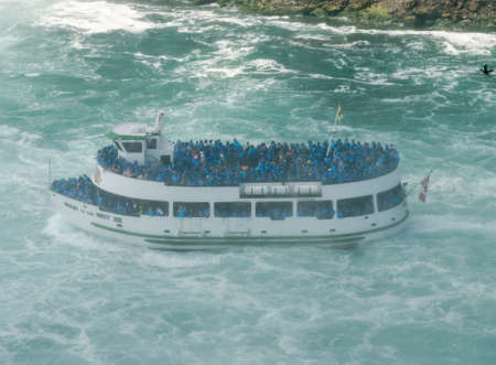 NIAGARA FALLS, CANADA - JULY 7: Maid of the Mist boat tour at dense mist on July 7, 2012 in Niagara Falls, Canada. The Maid of the Mist is a boat tour of Niagara Falls.のeditorial素材