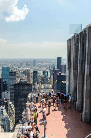NEW YORK CITY - JULY 12: People look at Manhattan from Rockefeller Center Observation Deck on July 12, 2012 in New York. Manhattan is a major commercial, economic, and cultural center of the United States.のeditorial素材