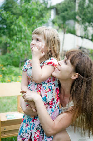 Lottle girl with mother looking upの写真素材