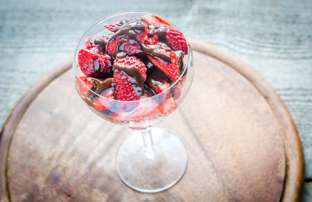 Fresh strawberries under chocolate toppingの写真素材