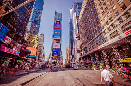 NEW YORK CITY - JULY 22: Undefined people pass through Times Square on July 22, 2014 in New York. Times Square is a major commercial intersection in Manhattan, at the junction of Broadway and 7th Ave.のeditorial素材