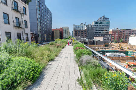 NEW YORK CITY - JULY 22: People walk along the High Line Park on July 22, 2014. The High Line is a...