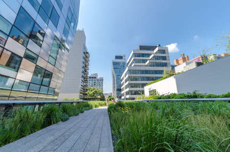 NEW YORK CITY - JULY 22: People walk along the High Line Park on July 22, 2014. The High Line is a...