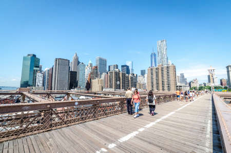NEW YORK - JULY 17: People walk on Brookly Bridgre in New York City on July 17, 2014. The Brooklyn Bridge is a bridge in New York City and is one of the oldest suspension bridges in the United States.のeditorial素材