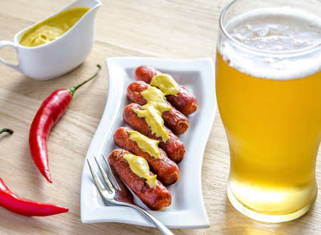 sausages on white plate with beerの写真素材