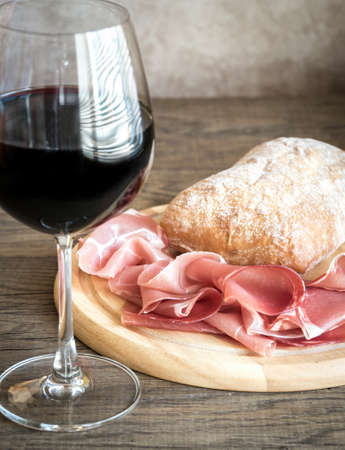 Red wine with ciabatta and prosciuttoの写真素材