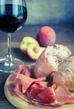 Red wine with ciabatta and prosciuttoの写真素材