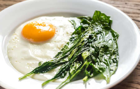 Fried eggs with spinachの写真素材