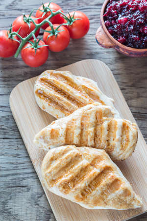 Grilled chicken with fresh cherry tomatoesの写真素材