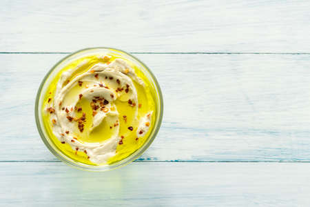 Bowl of hummus on the wooden tableの写真素材