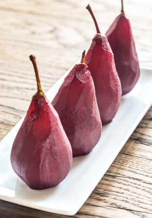 Merlot-poached pears on the plateの写真素材