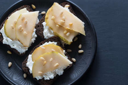 Sandwiches with cream cheese, pear and pine nutsの写真素材