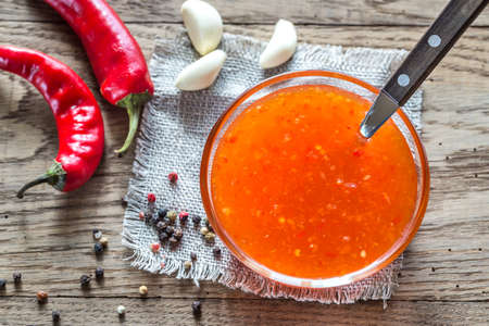 Glass bowl of thai sweet chili sauceの写真素材