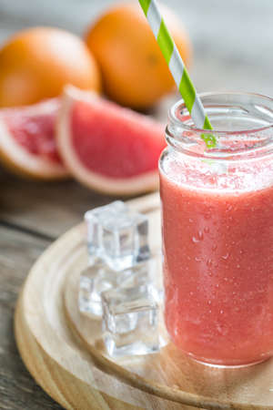 Glass jar of grapefruit smoothieの写真素材