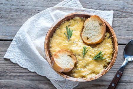 Bowl of onion soup on the wooden table