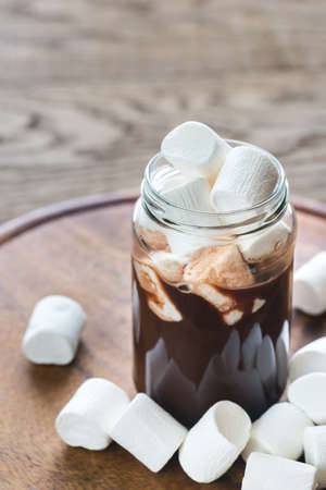 Glass jar of hot chocolate with marshmallowsの写真素材