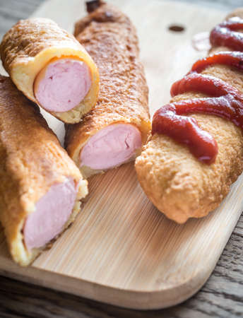 Corn dogs on the wooden boardの写真素材