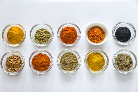Different kinds of spices and herbs on the white backgroundの写真素材