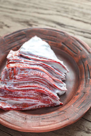 Portion of red velvet crepe cake on the wooden tableの写真素材