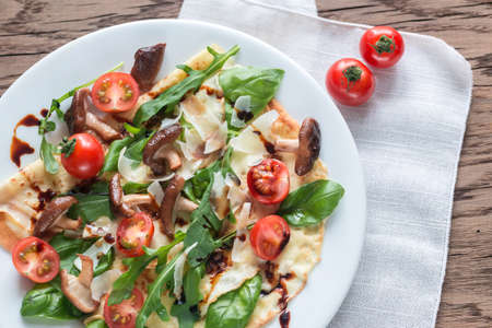 Crepes with cherry tomatoes, italian cheese, mushrooms and arugulaの写真素材
