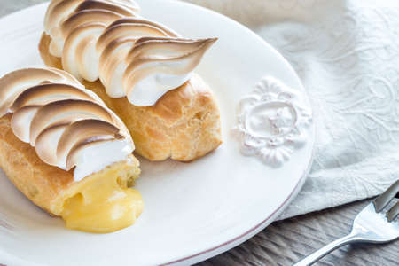 Eclairs with lemon curd and meringue