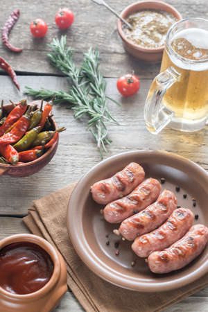 Grilled sausages with mug of beerの写真素材