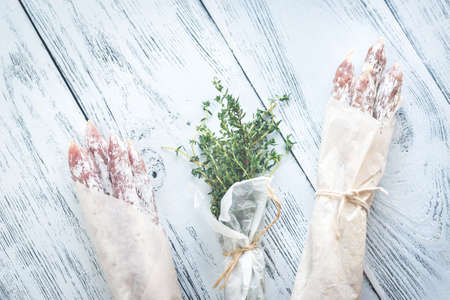 Fuet sausages in wrapping paperの写真素材