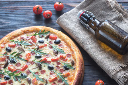 Cooked pizza with beerの写真素材