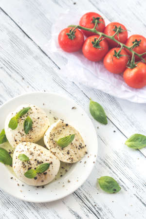 Mozzarella with cherry tomatoes and basil leavesの写真素材