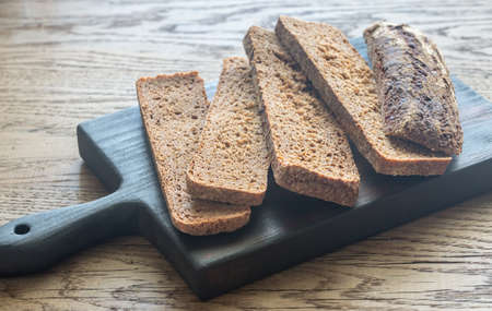 Slices of rye bread on the wooden boardの写真素材