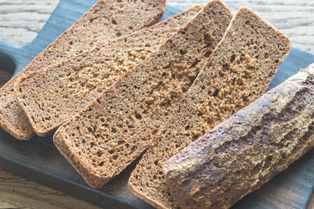 Slices of rye bread on the wooden boardの写真素材