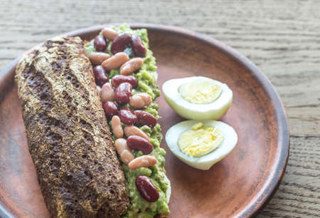 Sandwich with smashed avocado and kidney beansの写真素材