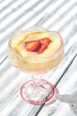 Sabayon with strawberry slices on the wooden background