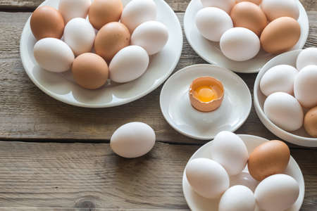 Raw chicken eggs on the wooden background