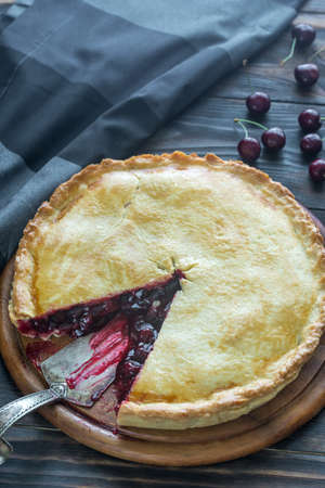 Cherry pie on the wooden background