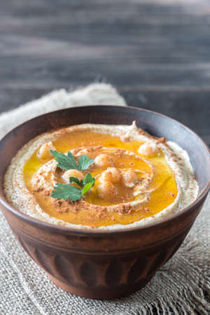 Bowl of hummus on the wooden table