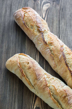 Two baguettes on the wooden backgroundの写真素材