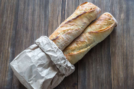 Two baguettes on the wooden backgroundの写真素材
