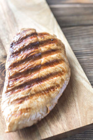 Grilled turkey breast on the wooden boardの写真素材