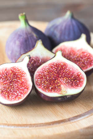 Ripe figs on the wooden boardの写真素材