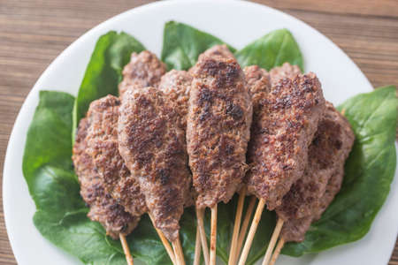 Beef cabobs on the fresh spinach leaves
