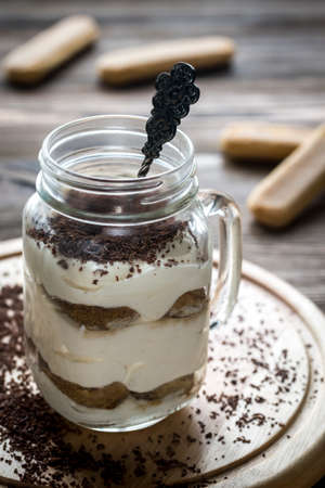 Tiramisu in the mason jar on the wooden backgroundの写真素材