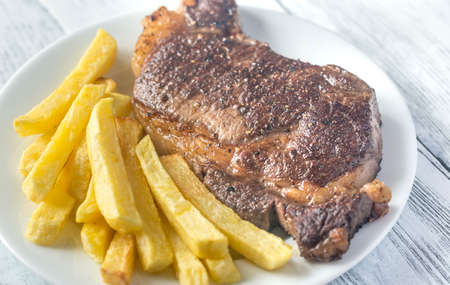 Beef steak with fried potatoes on the plateの写真素材