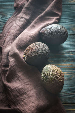 Hass avocados on the wooden backgroundの写真素材