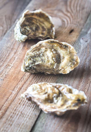 Raw oysters on the wooden background