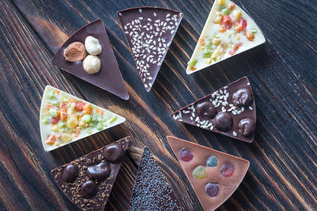 Chocolate candies with different toppingsの写真素材