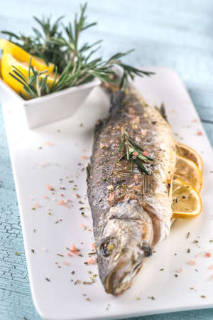 Baked sea bass with lemon and rosemaryの写真素材