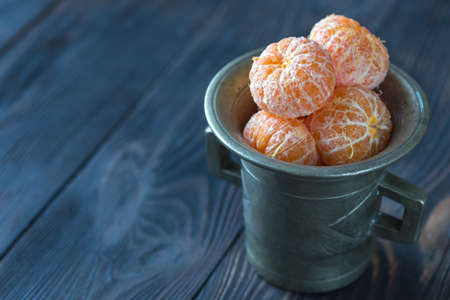 Peeled tangerines in the vintage cupの写真素材
