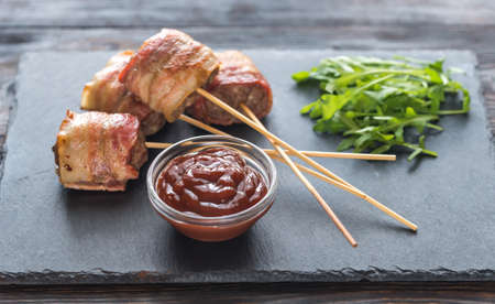 Bacon-wrapped beef skewers stuffed with mozzarellaの写真素材